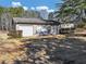 Large detached garage with multiple doors and surrounding landscaping at 1891 Highway 81 E, Mcdonough, GA 30252