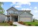 Two-story house with gray siding, beige garage door, and landscaping at 3152 Birdsong Ave, Covington, GA 30016