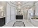 Luxurious bathroom featuring dual vanities, a glass-enclosed shower, and elegant lighting at 971 Saint Lyonn Cts, Marietta, GA 30068