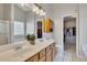 Bright bathroom with double sinks, a large mirror, and neutral tile flooring adjacent to separate closets at 102 River Marsh Ln, Woodstock, GA 30188