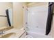 Cozy bathroom featuring a shower-tub combo with light tile surround, complemented by a granite sink and vanity at 2710 Royston Dr, Duluth, GA 30097