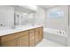 Bright bathroom with double vanity, separate tub, and glass-enclosed shower for a spa-like experience at 5707 Tillman Way, Powder Springs, GA 30127