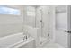 Modern bathroom features a soaking tub and glass-enclosed shower, creating a spa-like retreat at 5707 Tillman Way, Powder Springs, GA 30127