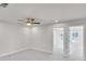 Bright bedroom with a ceiling fan and doorway leading to another room, showcasing ample natural light at 5707 Tillman Way, Powder Springs, GA 30127