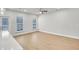 Spacious living room with hardwood floors, and ample natural light from the windows and door at 5707 Tillman Way, Powder Springs, GA 30127