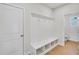 Bright mudroom with built-in bench, cubbies, coat hooks and a door leading to a well-lit bathroom at 5707 Tillman Way, Powder Springs, GA 30127
