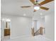 Upstairs landing, featuring a ceiling fan, staircase, and a glimpse of the adjacent bathroom at 5707 Tillman Way, Powder Springs, GA 30127