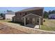 A brick two-story house features a covered patio and a spacious backyard at 318 Delta Dr, Mcdonough, GA 30253