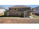 A brick two-story house features a covered patio and a well-maintained yard at 318 Delta Dr, Mcdonough, GA 30253