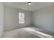 Bright bedroom features neutral carpet and a window providing natural light at 318 Delta Dr, Mcdonough, GA 30253