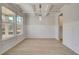 Inviting dining room featuring coffered ceilings, bright windows, light wood floors, and classic wainscoting at 318 Delta Dr, Mcdonough, GA 30253
