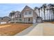 Charming two-story home with a two-car garage, well-maintained lawn, and classic brick exterior at 318 Delta Dr, Mcdonough, GA 30253