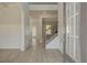 Bright foyer with light wood floors, white wainscoting, staircase with iron spindles, and a modern front door at 318 Delta Dr, Mcdonough, GA 30253