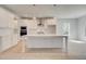 Bright kitchen with an island, stainless vent hood, white cabinets, and pendant lighting at 318 Delta Dr, Mcdonough, GA 30253