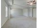 Large main bedroom featuring neutral carpet and multiple windows for ample light at 318 Delta Dr, Mcdonough, GA 30253
