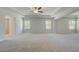 Spacious main bedroom with neutral carpet, multiple windows, and a ceiling fan at 318 Delta Dr, Mcdonough, GA 30253