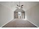 Attic featuring carpeted floors, vaulted ceiling, built-in shelves, and a window at 105 Remington Ct, Woodstock, GA 30188