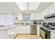 Modern kitchen featuring granite countertops, stainless steel appliances, and white cabinets at 23 Rumson Se Ct, Smyrna, GA 30080