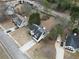 Aerial view of a neighborhood with houses featuring well-maintained yards and driveways at 59 Pompas Ct, Dallas, GA 30157