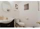 Well-lit half bathroom with stylish vanity, oval mirror, and decorative wall hangings at 59 Pompas Ct, Dallas, GA 30157