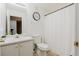 Cozy bathroom with white fixtures, shower curtain, and neutral tile flooring at 59 Pompas Ct, Dallas, GA 30157