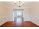 Spacious dining room with hardwood floors and an ornate chandelier features a pass-through to the living area at 59 Pompas Ct, Dallas, GA 30157