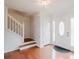 Bright foyer with hardwood floors, a white staircase, and a front door with decorative windows at 59 Pompas Ct, Dallas, GA 30157