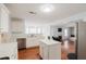 Open-concept kitchen with island flows into a living room with a fireplace and bay window at 59 Pompas Ct, Dallas, GA 30157