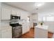Well-lit kitchen with white cabinetry, modern appliances, and a functional center island at 59 Pompas Ct, Dallas, GA 30157
