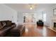 Bright living room showcases hardwood floors, fireplace, and an open concept view into the kitchen at 59 Pompas Ct, Dallas, GA 30157