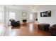 Spacious living room with hardwood floors, a fireplace, and lots of natural light from the windows at 59 Pompas Ct, Dallas, GA 30157