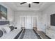 Relaxing bedroom featuring a tray ceiling, modern decor, and a glimpse into the attached bathroom at Tract1 Harmony Rd, Temple, GA 30179