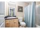 A bright bathroom with a light fixture, vanity and sink, toilet and shower/tub combination at 1165 Hardin Bridge Rd, Euharlee, GA 30145