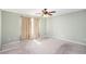 A cozy bedroom features a ceiling fan, neutral walls, and a large window dressed with curtains at 1165 Hardin Bridge Rd, Euharlee, GA 30145