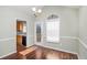Cozy dining room featuring hardwood floors, a view of the backyard and a stylish light fixture at 1165 Hardin Bridge Rd, Euharlee, GA 30145