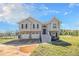 Charming two-story home with a two-car garage and steps leading to the front door under a blue sky at 1165 Hardin Bridge Rd, Euharlee, GA 30145