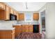 Functional kitchen with wooden cabinets, black appliances and lots of natural light at 1165 Hardin Bridge Rd, Euharlee, GA 30145