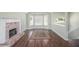 Inviting living room with hardwood floors, brick fireplace, and bright windows offering plenty of natural light at 1165 Hardin Bridge Rd, Euharlee, GA 30145