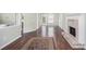 Inviting living room featuring hardwood floors, a brick fireplace, and views of the backyard at 1165 Hardin Bridge Rd, Euharlee, GA 30145
