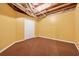 Unfinished basement offers ample storage space with neutral walls and carpet at 1464 Oglethorpe Dr, Suwanee, GA 30024