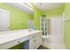 Full bathroom with shower/tub combo and green walls at 1464 Oglethorpe Dr, Suwanee, GA 30024