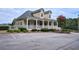 Exterior view of the neighborhood clubhouse with a welcoming veranda and accessible ramp at 1464 Oglethorpe Dr, Suwanee, GA 30024