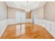 Formal dining room with hardwood floors, wainscoting, and a chandelier at 1464 Oglethorpe Dr, Suwanee, GA 30024