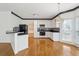 Bright kitchen with white cabinets, hardwood floors, and a breakfast area at 1464 Oglethorpe Dr, Suwanee, GA 30024