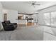 Open concept living room with kitchen view and hardwood floors at 1464 Oglethorpe Dr, Suwanee, GA 30024