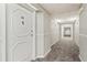 Well-lit hallway with patterned carpeting and a white door with a door knocker at 2479 Peachtree Ne Rd # 605, Atlanta, GA 30305