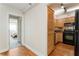 View of the kitchen off of the living area, with wood floors, wooden cabinets and black appliances at 2479 Peachtree Ne Rd # 605, Atlanta, GA 30305