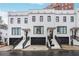 Stunning white brick townhomes featuring black trim and attached garages, offering modern elegance at 3667 Peachtree Ne Rd # 16, Atlanta, GA 30319