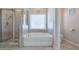 Bathroom features a walk-in shower and a separate soaking tub at 1868 Lakeview Bend Way, Buford, GA 30519