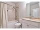Clean bathroom with a shower/tub combo, vanity, and neutral tile at 1868 Lakeview Bend Way, Buford, GA 30519